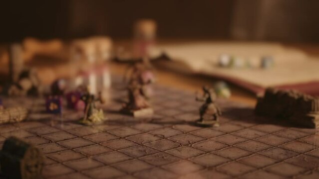 A person playing a tabletop roleplaying game with dice and miniatures