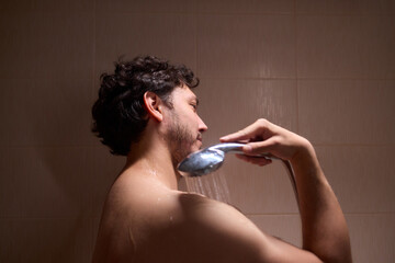 A man is taking a shower, enjoying the clean water to ensure good hygiene and relaxation