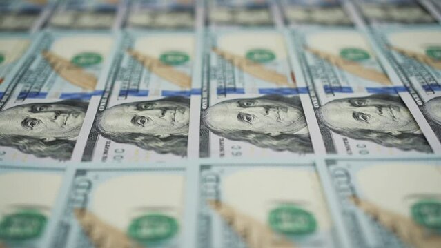 Rows of hundred dollar bills arranged neatly, showcasing detailed features of US currency. Concept of finance, wealth, and economic growth.