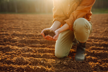 Farmer- woman is checking soil quality before sowing. Agriculture, gardening or ecology concept.