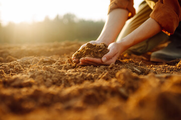 Farmer- woman is checking soil quality before sowing. Agriculture, gardening or ecology concept.
