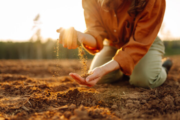 Farmer- woman is checking soil quality before sowing. Agriculture, gardening or ecology concept.