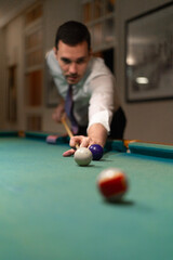 man playing pool, pool balls on the table