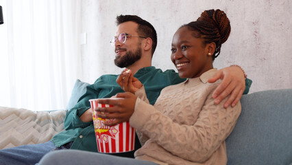 Couple watching some fun comedy movie at home	