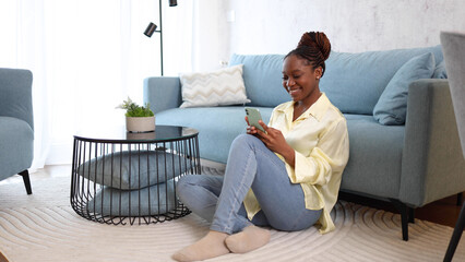 Happy woman relaxing at home and having fun online	