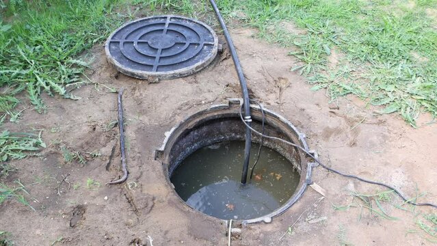 Maintenance hole of septic tank to pumping sewage using submersible wastewater pump.