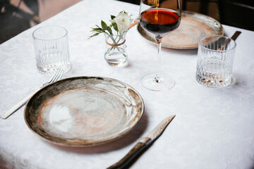 Table served for dinner with red wine in a restaurant.