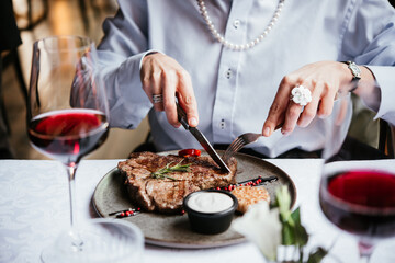 Beef steak served with red wine for dinner at a restaurant.