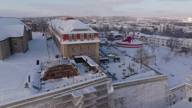Aerial Panning Shot Of Life-Size Christmas Crib In Market On Snowy Landscape - Erfurt, Germany