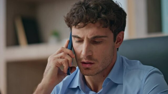 Frustrated guy calling smartphone in home office closeup. Unhappy customer solve