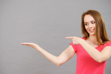 Woman points to open empty hand