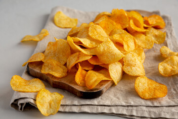 Cheese Potato Chips on a Wooden Board, side view.