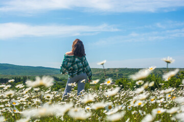 Girl in a chamomile field