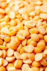 Uncooked, split, yellow peas background. Dry peas grains. Close-up