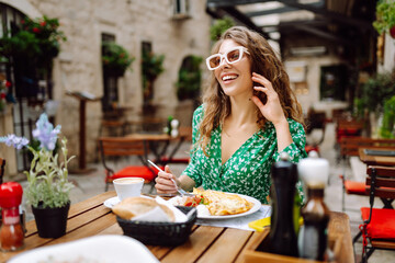 Woman eating italian pasta and drinking coffee at restaurant on the street in Rome. Concept of Italian gastronomy and travel. Tourism, food and drink.