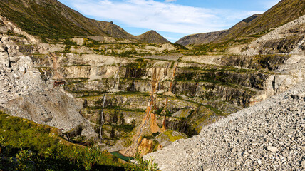 There is a large pile of rocks in the middle of the majestic mountains