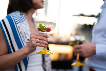 holding cool fresh alcoholic cocktail in hands at party