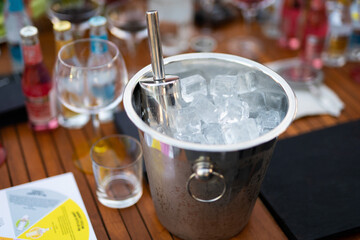 an ice bucket with a spatula in a restaurant for cooling drinks