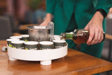 bartender pours into glasses rum Captain Morgan