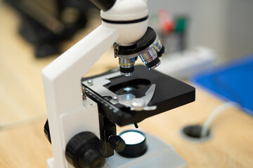 professional microscope in a school laboratory for the study of cells and bacteria