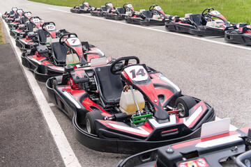 Red black go-karts on the side of a track