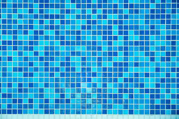 A pattern of small blue mosaic tiles. The bottom of the pool.