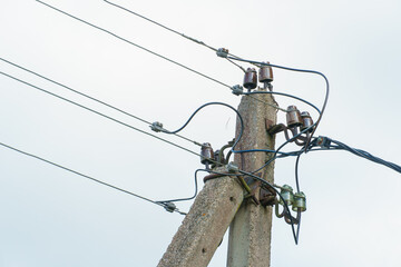 Power lines and high-voltage wires against a background of blue sky and fluffy clouds. Energy...