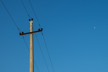 Power lines and high-voltage wires against a background of blue sky and fluffy clouds. Energy...