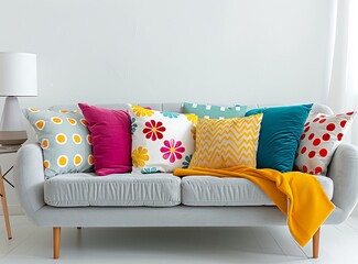Bright living room interior with a grey sofa, colorful pillows and white walls