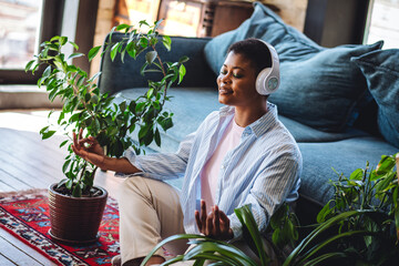 Concept of mental health, work life balance, disconnection. Young woman meditating, listening to...