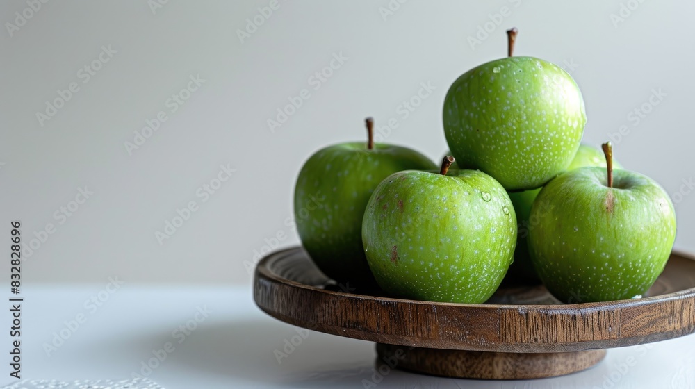 Poster green apples on wood stand against white backdrop