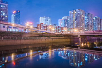 Twilight cityscape with reflective waterway