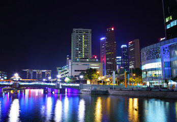 Illuminated city skyline at night by waterfront