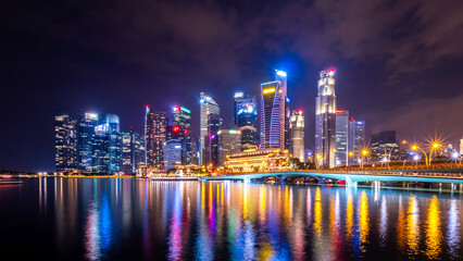 Dazzling city skyline at night with reflective waterfront