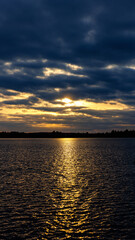 The sun is setting, casting a warm glow on the water