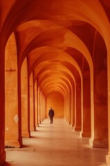 Obraz premium A solitary figure walks through a series of striking orange arches in an architectural corridor. 