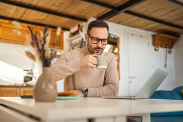 Portrait of adult caucasian man sit at home and hold cup of coffee