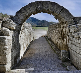 The entrance arch leading to the famous Olympic stadium, in the ancient Olympia complex,...