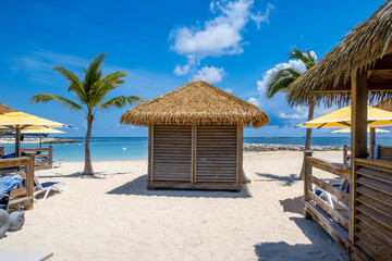 Cabanas on white sand beach in Caribbean islands during day time.