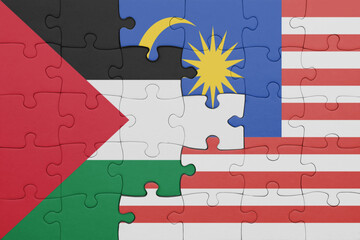 puzzle with the colourful national flag of malaysia and flag of palestine.