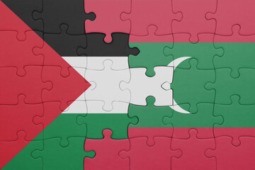 puzzle with the colourful national flag of maldives and flag of palestine.