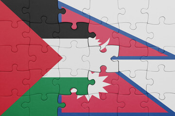 puzzle with the colourful national flag of nepal and flag of palestine.