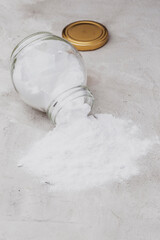 Baking soda in glass container on rustic surface
