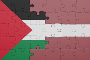 puzzle with the colourful national flag of latvia and flag of palestine.