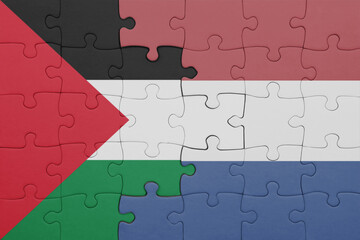 puzzle with the colourful national flag of netherlands and flag of palestine.