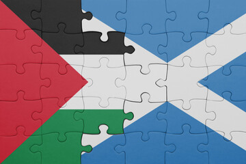 puzzle with the colourful national flag of scotland and flag of palestine.