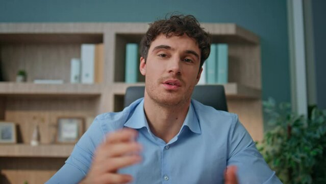 Pov entrepreneur talking camera interview in office. Online coach waving hand