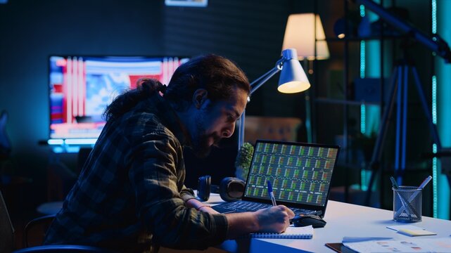 Joyous broker investor throwing fist in air from excitement after personal stock rising, happy about profit. Upbeat man celebrating in living room after noticing market shares growth, camera B - Powered by Adobe