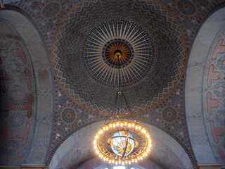 Intricate ceiling design of the Los Angeles Central Library, showcasing detailed patterns and a central chandelier.