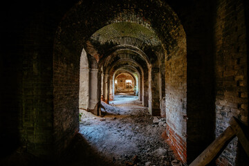 Fototapeta premium Large ancient vaulted corridor of abandoned church, castle etc